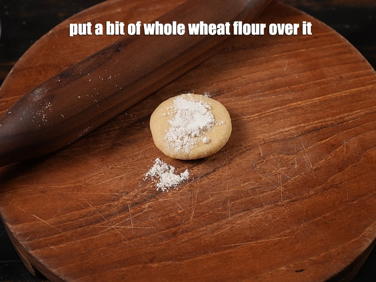 Step 9 – <p><span style="background-color:rgb(255,255,255);color:rgb(0,0,0);">put a bit of whole wheat flour (gehun ka atta) over it.</span></p>
