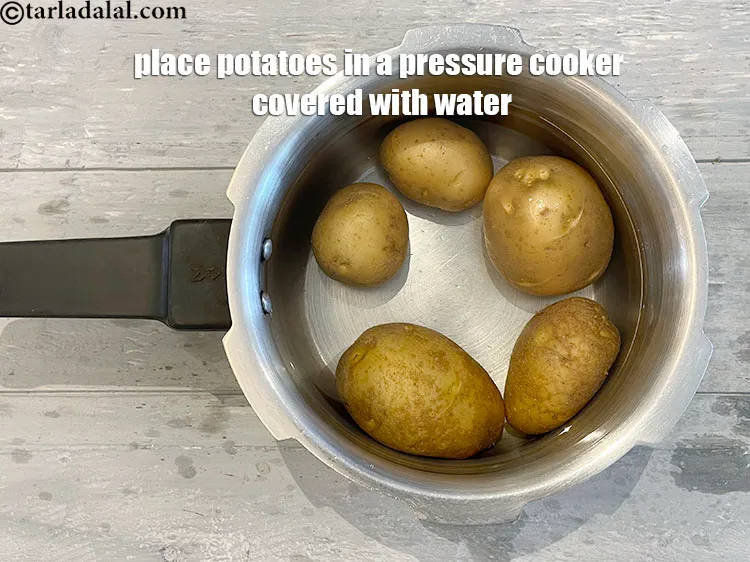 Step 19 – <p>Place potatoes in a flat dish in a pressure cooker covered with water.</p>