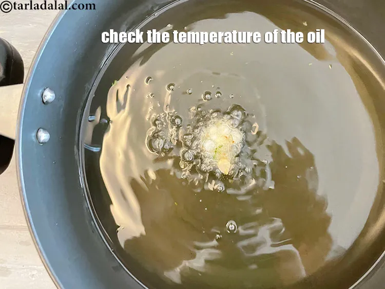 Step 36 – <p>Before dropping the&nbsp;sabudana vadas, check the temperature of the oil by dropping a small portion …