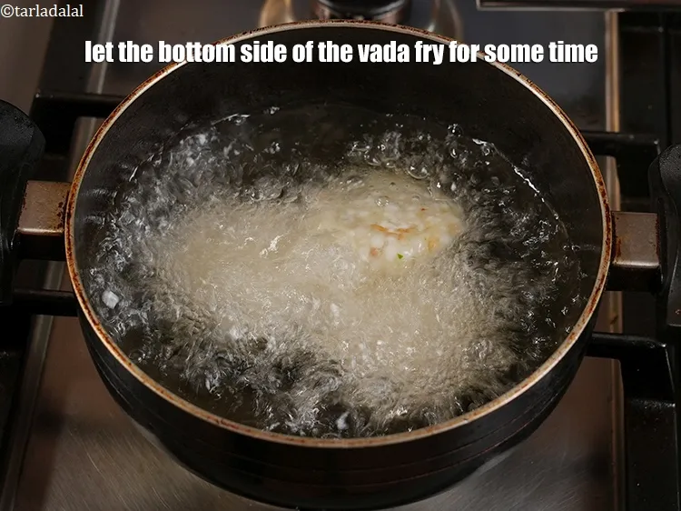 Step 35 – <p>Let the bottom side of the vada fry for some time. Don't rush in flipping …