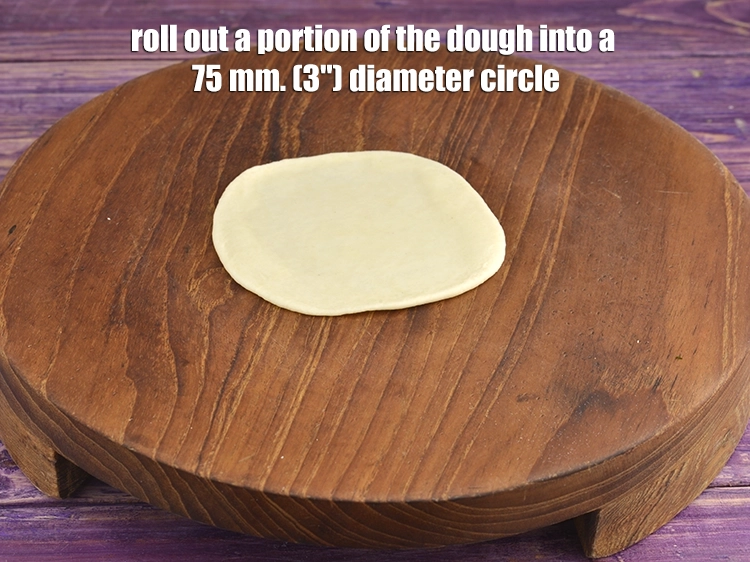 Step 6 – <p><span style="background-color:rgb(255,255,255);color:rgb(0,0,0);">Roll out a portion of the dough into a 75 mm. (3") diameter circle.</span></p>