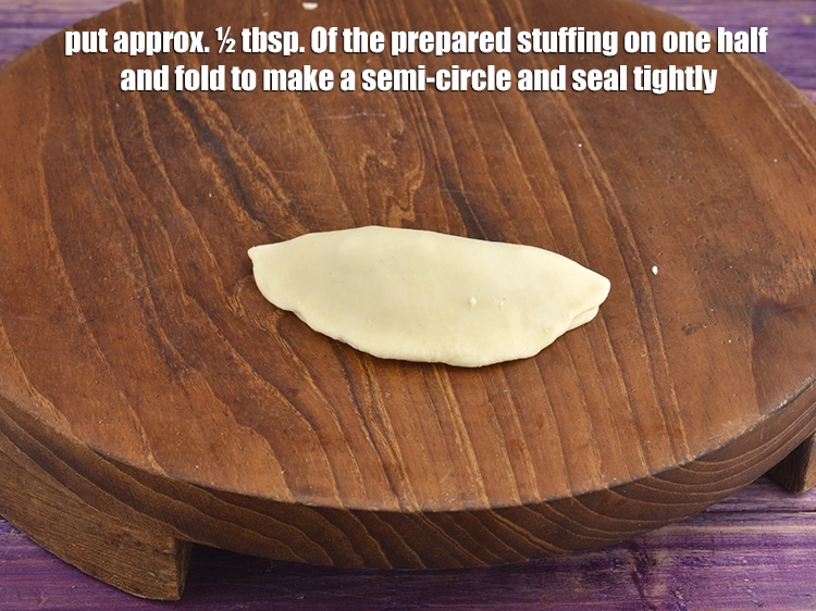 Step 7 – <p><span style="background-color:rgb(255,255,255);color:rgb(0,0,0);">Put approx. ½ tbsp. Of the <strong>prepared stuffing</strong> on one half and fold to …