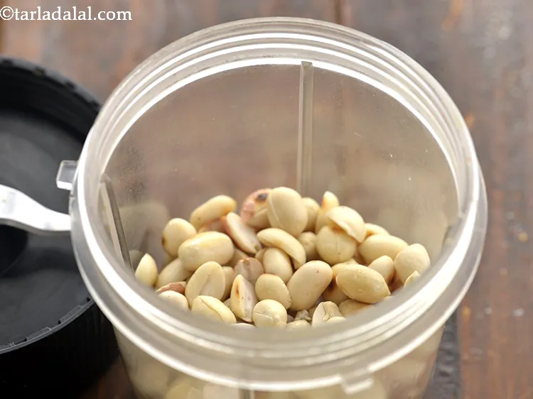 Step 7 – <html><head><meta charset="UTF-8"></head><body><p>Transfer the peanuts to a mixer jar after cooling them slightly.&nbsp;</p></body></html>