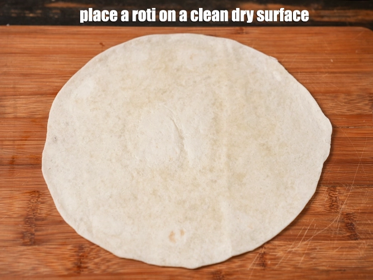 Step 26 – <p>Place a <a href="https://www.tarladalal.com/glossary-tortilla-wraps-2407i"><u>tortilla wraps</u></a> or roti (8 inches) on a clean dry surface.</p>