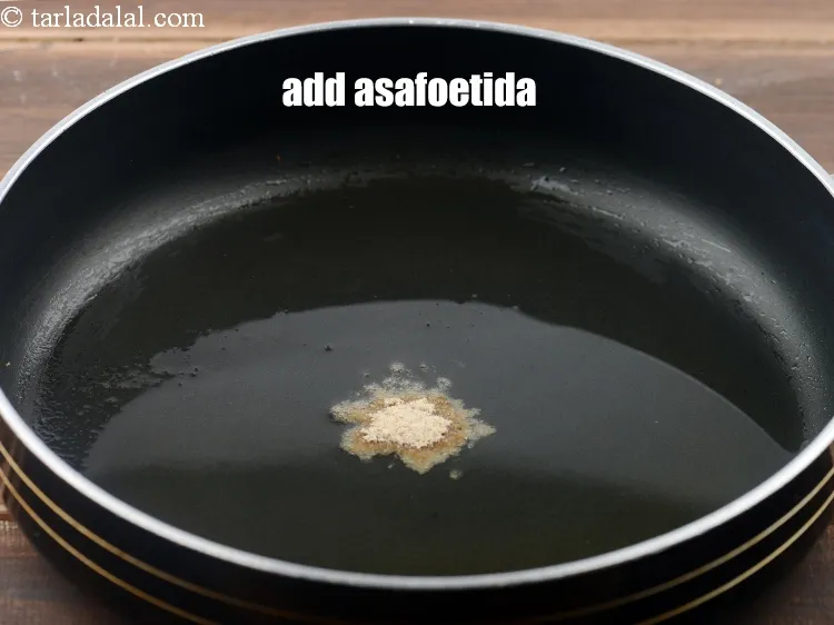 Step 9 – <p>Add <span style="background-color:rgb(255,255,255);color:rgb(0,0,0);">the </span><a href="https://www.tarladalal.com/glossary-asafoetida-hing-113i"><u>asafoetida (hing)</u></a>.</p>