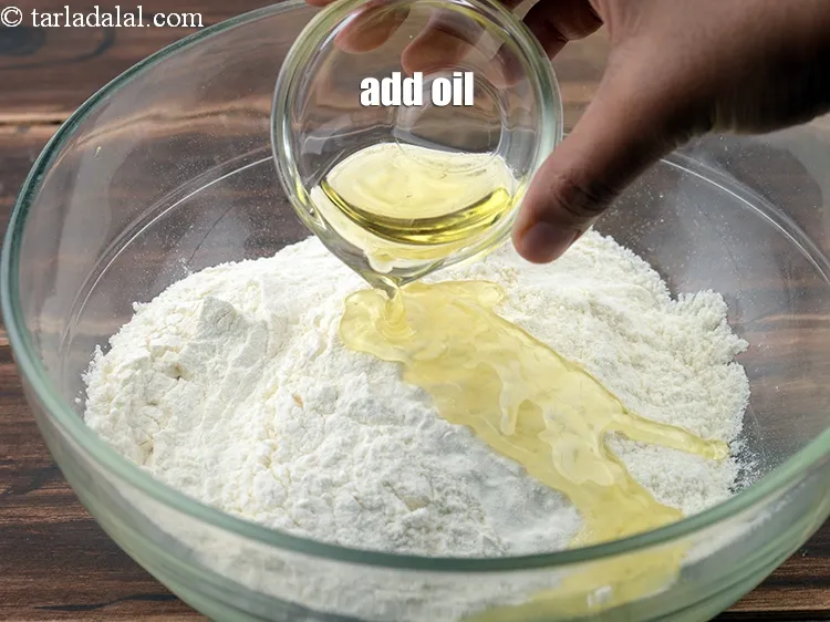 Step 2 – <p><span style="background-color:rgb(255,255,255);color:rgb(0,0,0);">Add the oil or 1/2 tsp melted </span><a href="https://www.tarladalal.com/glossary-ghee-245i"><u>ghee</u></a>.</p>