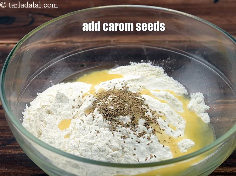Step 3 – <p><span style="background-color:rgb(255,255,255);color:rgb(0,0,0);">Add the </span><a href="https://www.tarladalal.com/glossary-carom-seeds-ajwain-Thymol-seeds-bishops-weed-266i"><u>carom seeds (ajwain)</u></a><u>.</u></p>
