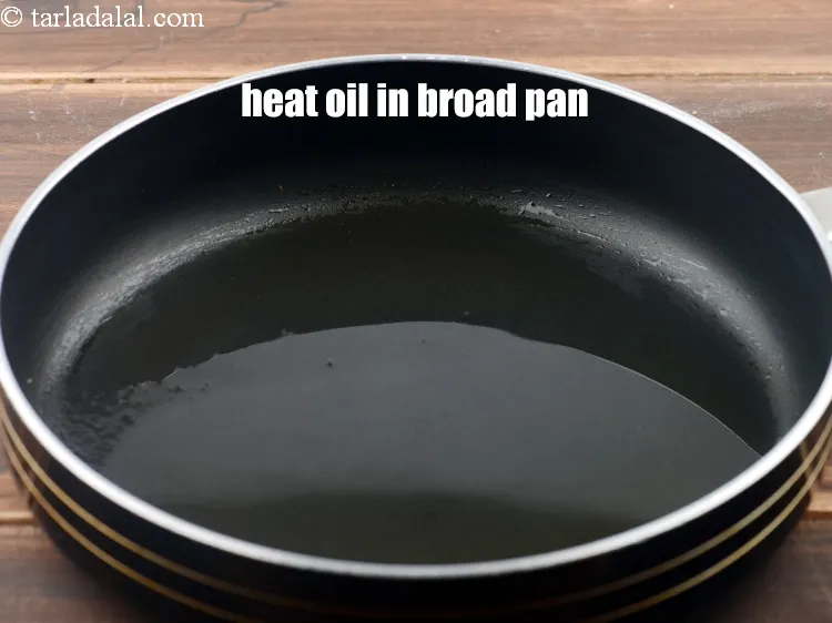 Step 8 – <p><span style="background-color:rgb(255,255,255);color:rgb(0,0,0);">Heat 1 tbsp </span><a href="https://www.tarladalal.com/glossary-oil-671i"><u>oil</u></a><span style="background-color:rgb(255,255,255);color:rgb(0,0,0);"> in a broad non-stick pan</span></p>