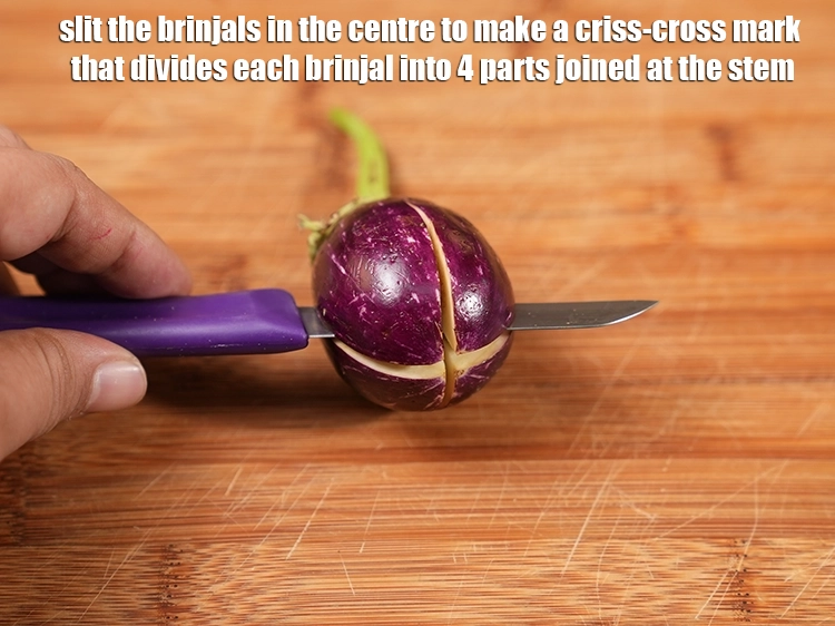 Step 18 – <p>First wash and wipe dry, then slit the <a href="https://www.tarladalal.com/glossary-brinjal-baingan-eggplant-aubergine-128i"><u>brinjal (baingan / eggplant)</u></a> in the …