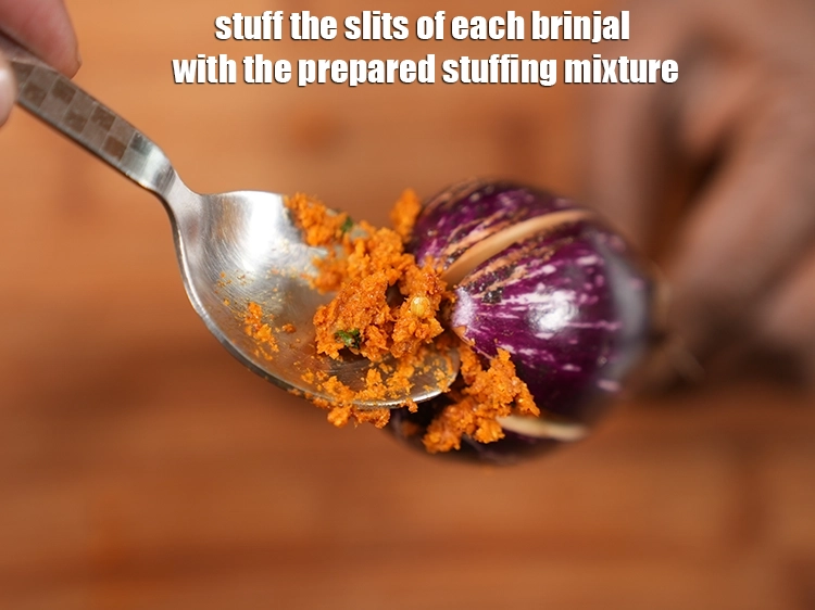 Step 19 – <p>Stuff the slits of each brinjal with the prepared stuffing masala and keep the remaining …