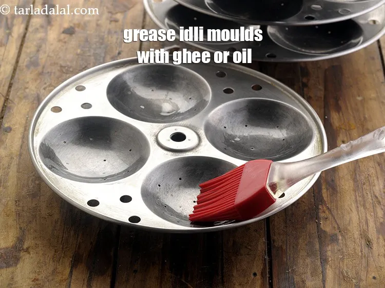 Step 5 – <p><span style="background-color:rgb(255,255,255);color:rgb(0,0,0);">Grease idli moulds with ghee or oil/</span></p>