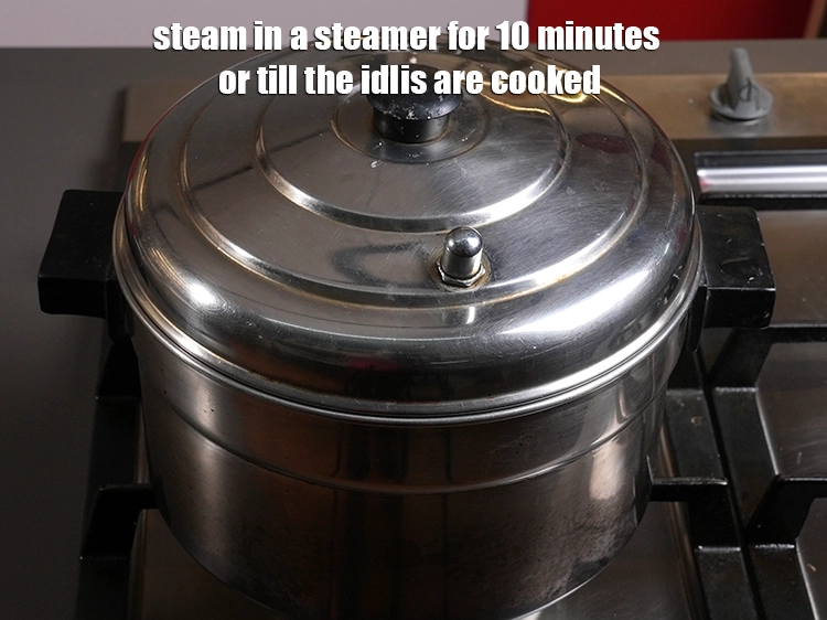 Step 7 – <p><span style="background-color:rgb(255,255,255);color:rgb(0,0,0);">Steam in a steamer for 10 minutes or till the idlis are cooked.</span></p>