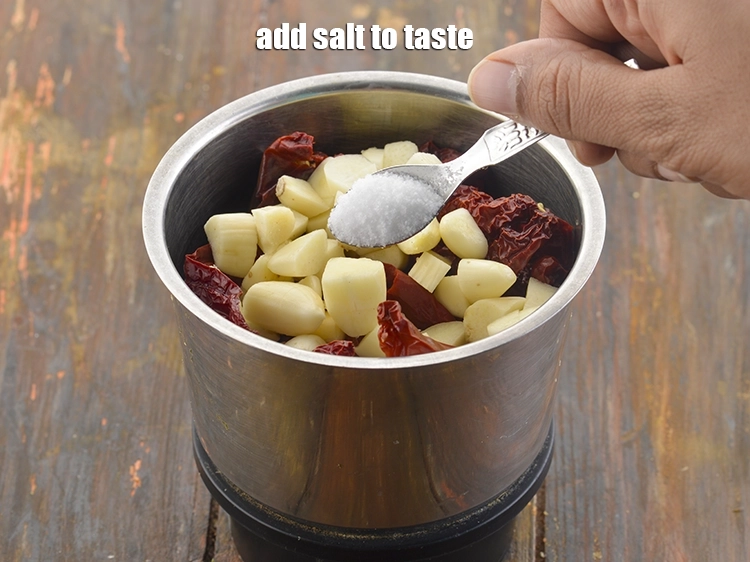 Step 13 – <p><span style="background-color:rgb(255,255,255);color:rgb(0,0,0);">Add </span><a href="https://www.tarladalal.com/glossary-salt-namak-table-salt-418i"><u>salt </u></a><span style="background-color:rgb(255,255,255);color:rgb(0,0,0);">to taste as per taste to the </span><strong>Chilli Garlic Chutney.</strong></p>