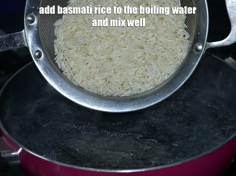 Step 7 – <p>Add the&nbsp;<span style="background-color:rgb(255,255,255);color:rgb(0,0,0);">1 cup </span><a href="https://www.tarladalal.com/glossary-long-grain-rice-basmati-chawal-basmati-rice-535i"><u>long grain rice (basmati chawal)</u></a>&nbsp;to the boiling water and mix …