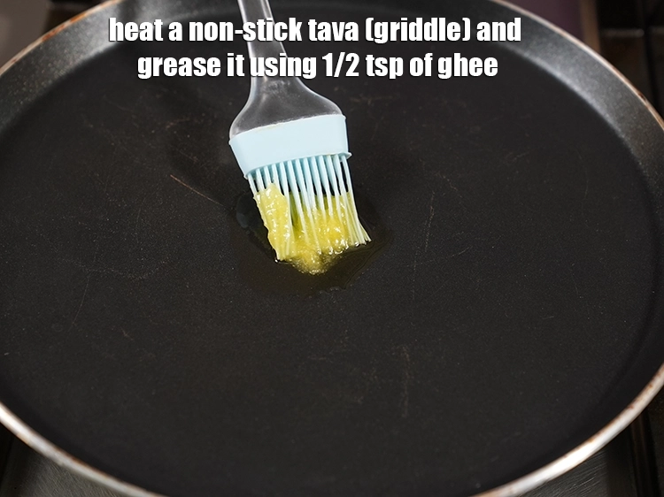 Step 15 – <p>Heat a non-stick tava (griddle) and grease it using 1/2 tsp of <a href="https://www.tarladalal.com/glossary-ghee-245i"><u>ghee</u></a>. This …