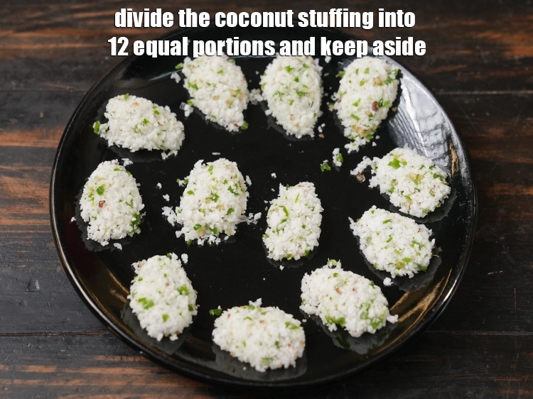 Step 6 – <p>Divide the coconut stuffing into 12 equal portions and keep aside.</p>