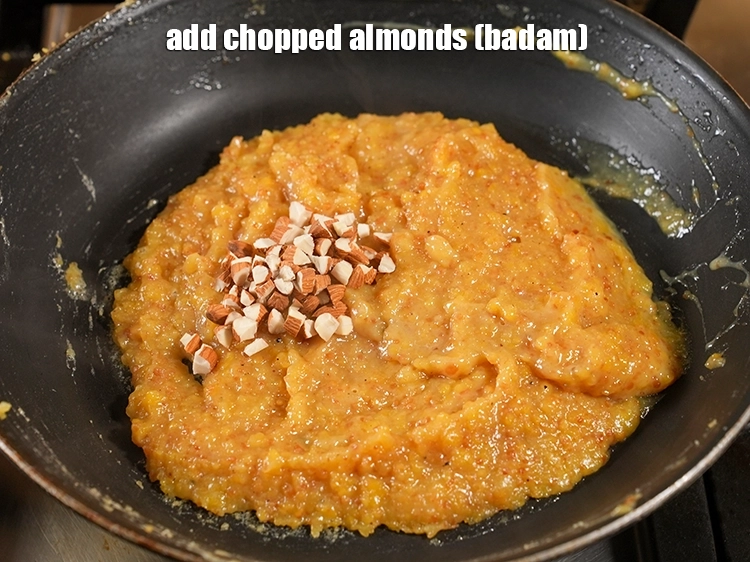 Step 21 – <p><span style="background-color:rgb(255,255,255);color:rgb(0,0,0);">Add 1 tbsp </span><a href="https://www.tarladalal.com/glossary-almonds-badam-378i#ing_3231"><u>chopped almonds (badam)</u></a><u>.</u></p>