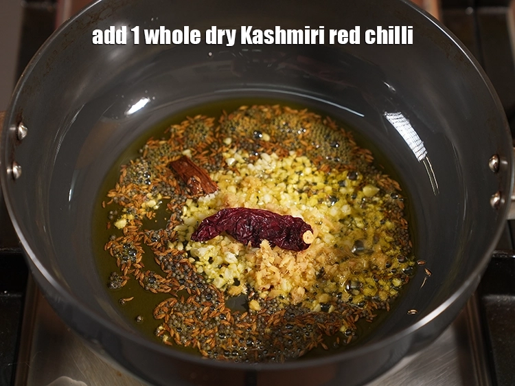 Step 22 – <p>Add <span style="background-color:rgb(255,255,255);color:rgb(0,0,0);">1 </span><a href="https://www.tarladalal.com/glossary-whole-dry-kashmiri-red-chillies-kashmiri-mirch-kashmiri-lal-mirch-332i"><u>whole dry Kashmiri red chilli</u></a><u>.</u></p>