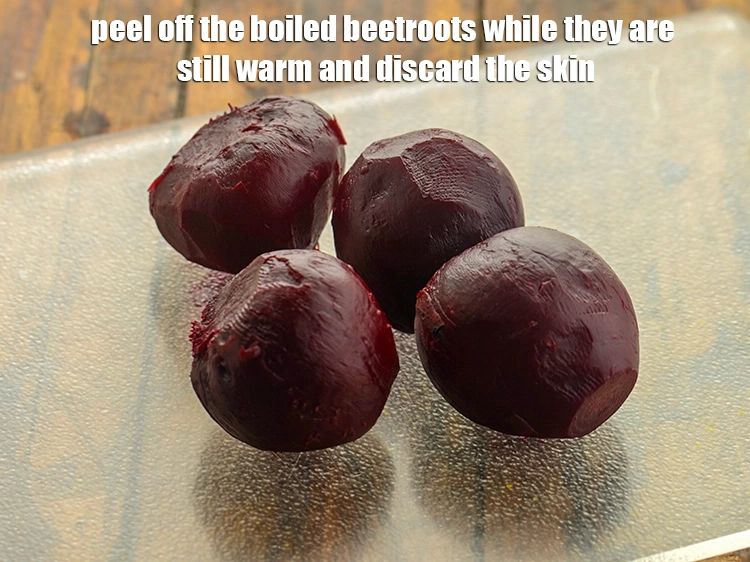 Step 14 – <p>Peel off the boiled <a href="https://www.tarladalal.com/glossary-beetroot-chukandar-201i#">beetroots</a> while they are still warm and discard the skin. …