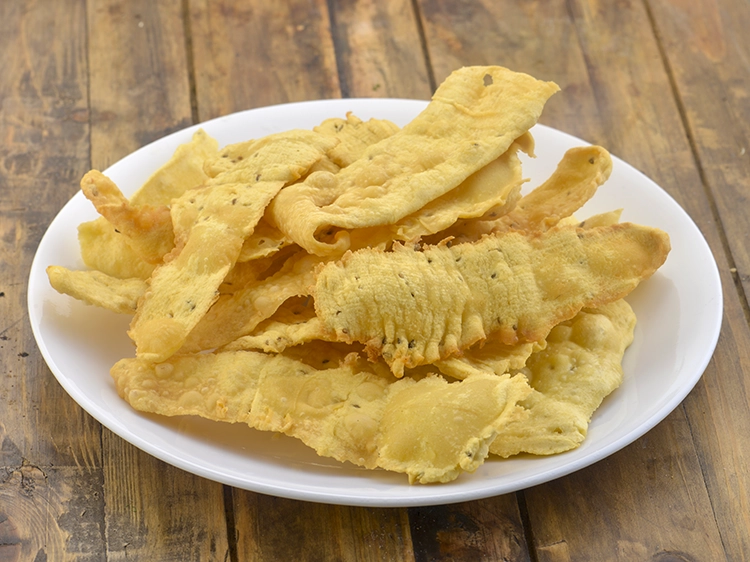 Step 26 – <p>Heat the <a href="https://www.tarladalal.com/glossary-oil-671i">oil</a>&nbsp;in a deep non-stick pan and deep-fry a few fafda on a …