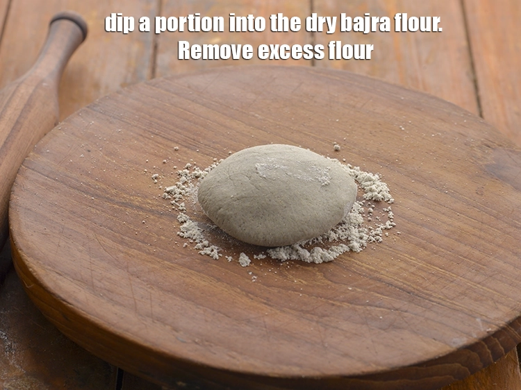 Step 12 – <p>Dip a portion into the dry bajra flour. Remove excess flour.</p>