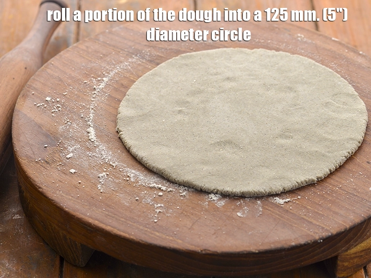 Step 13 – <p>Roll a portion of the dough into a 125 mm. (5") diameter circle, using a …