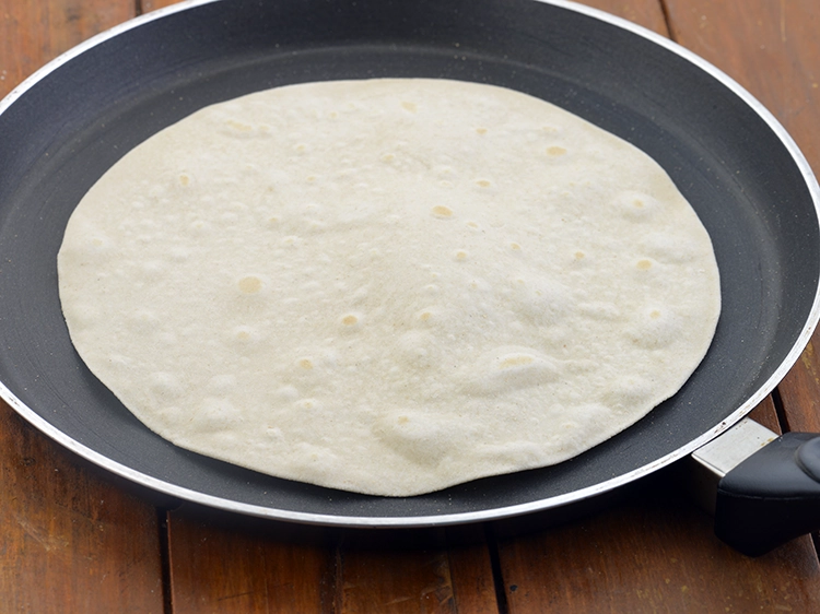 Step 39 – <p><span style="background-color:rgb(255,255,255);color:rgb(0,0,0);">To cook the roti, heat a non-stick tava (griddle) and place the roti</span></p>