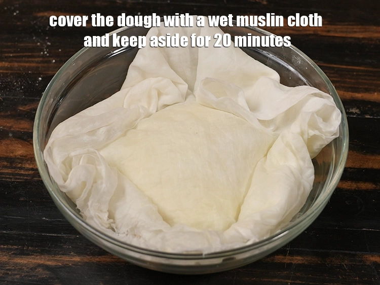 Step 10 – <p><span style="background-color:rgb(255,255,255);color:rgb(0,0,0);">Cover the dough with a wet muslin cloth and keep aside for 20 minutes.</span></p>