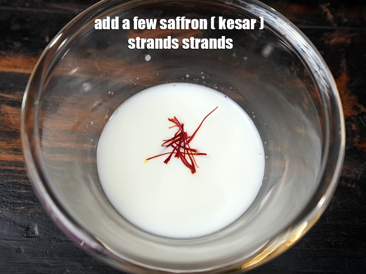 Step 16 – <html><head></head><body><p>Add&nbsp;a few&nbsp;<a href="glossary-saffron-kesar-520i">saffron (kesar) strands</a>. <strong>TIP.</strong>&nbsp;The colour of the halwa depends on the quality of …