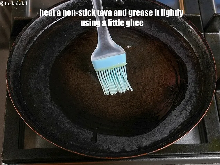 Step 13 – <p>Heat a non-stick tava (griddle) and grease it lightly using a little ghee.</p>