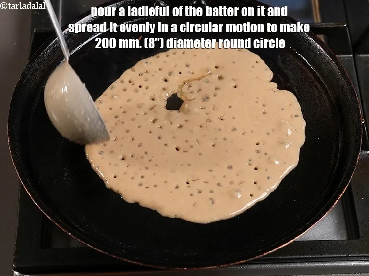 Step 14 – <p>Pour a ladleful of the batter on it and spread it evenly in a circular …