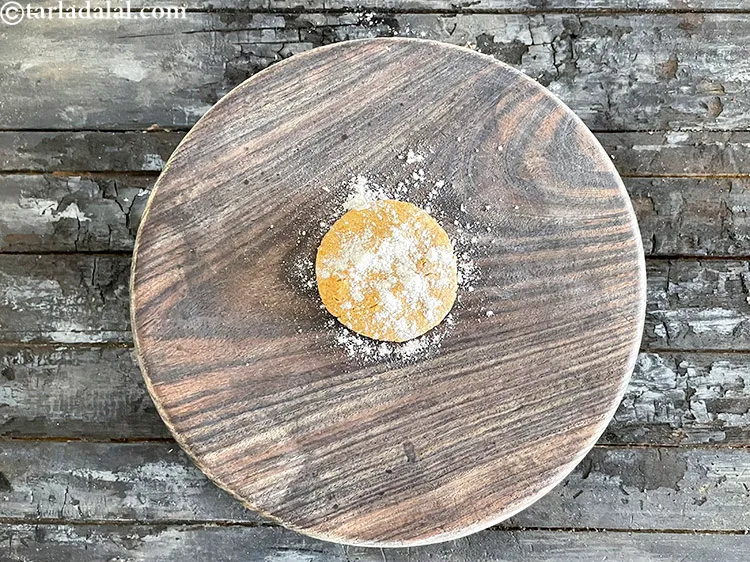 Step 25 – <p>Take one portion of dough, roll it in between your palms and flatten it on …