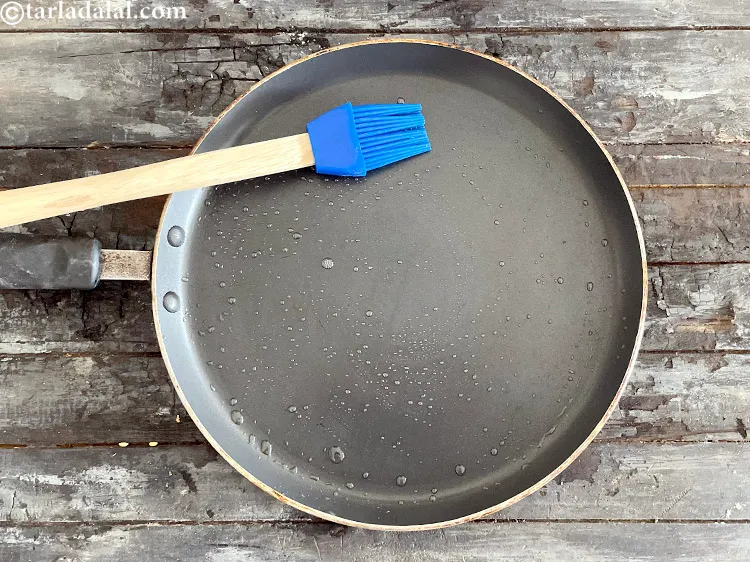 Step 27 – <html><head><meta charset="UTF-8"> </head><body><p>Heat a non-stick tava (griddle) and grease&nbsp;using ¼ tsp of oil.</p></body></html>