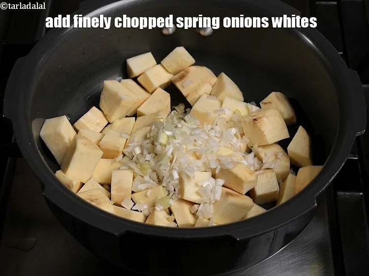 Step 4 – <p>Add ½ cup finely <a href="https://www.tarladalal.com/glossary-chopped-spring-onion-whites-815i">chopped spring onions whites</a>.</p>
