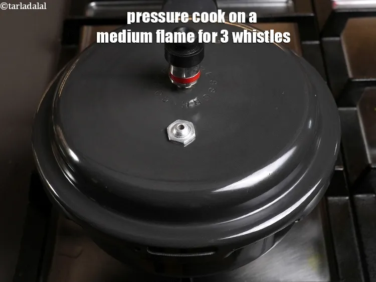 Step 6 – <p>Pressure cook on a medium flame for 3 whistles.</p>