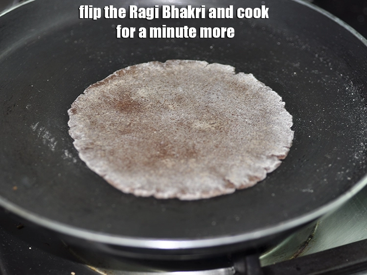 Step 15 – <p>Flip the <strong>Ragi Bhakri </strong>and cook for a minute more.</p>