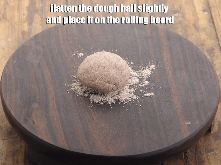 Step 11 – <p>Flatten the dough ball slightly and place it on the rolling board.&nbsp;</p>