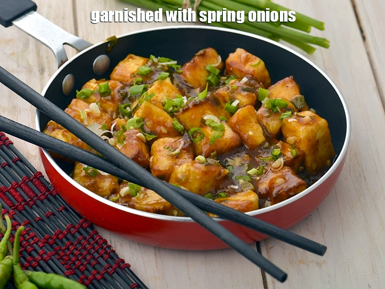 Step 12 – <p><span style="background-color:rgb(255,255,255);color:rgb(0,0,0);">Garnished with </span><a href="https://www.tarladalal.com/glossary-spring-onion-hara-pyaz-443i#ing_2384"><u>chopped spring onions whites </u></a><span style="background-color:rgb(255,255,255);color:rgb(0,0,0);">and greens.</span></p>