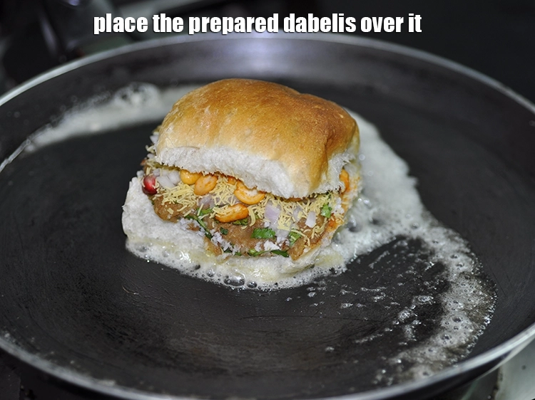 Step 26 – <p>Place the <strong>prepared dabelis</strong> over it.</p>