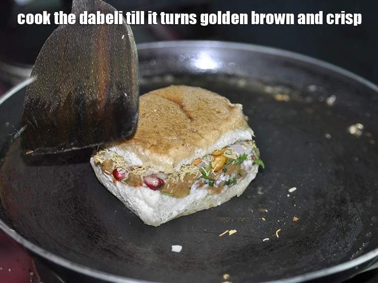 Step 27 – <p>Cook the <strong>dabeli </strong>till it turns golden brown and crisp.</p>