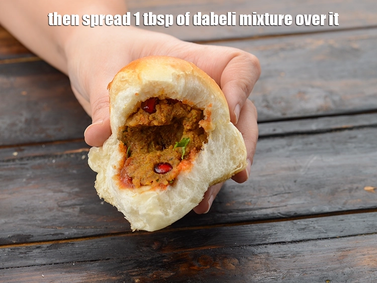 Step 33 – <p>Then spread 1 tbsp of <strong>dabeli mixture</strong> over it. Press it with the back of …