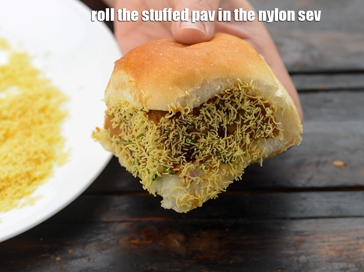 Step 38 – <p>Roll the stuffed pav in the <a href="https://www.tarladalal.com/glossary-sev-1137i#ing_3489"><u>nylon sev</u></a>.</p>
