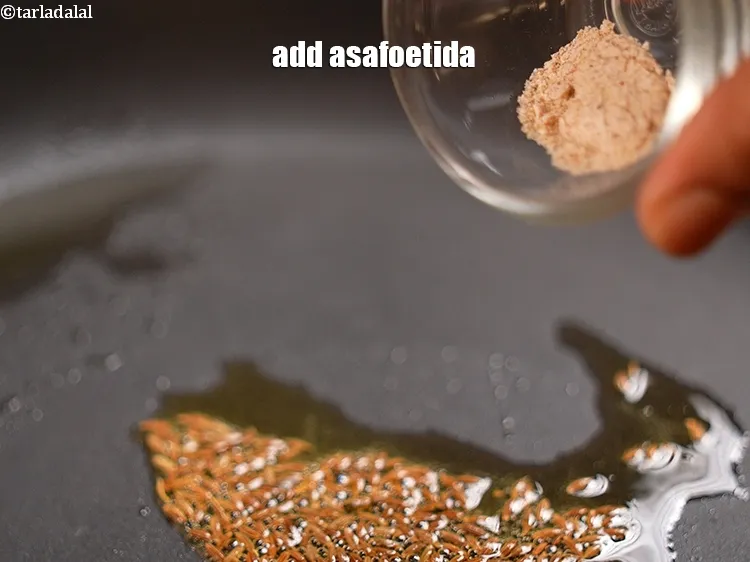 Step 9 – <p>Add <span style="background-color:rgb(255,255,255);color:rgb(0,0,0);">1/4 tsp </span><a href="https://www.tarladalal.com/glossary-asafoetida-hing-113i"><u>asafoetida (hing)</u></a><u>.</u></p>