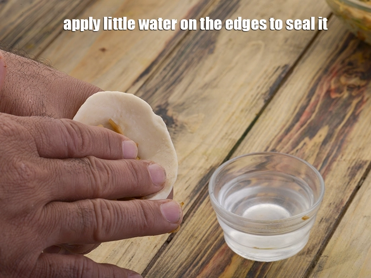 Step 12 – <p><span style="background-color:rgb(255,255,255);color:rgb(0,0,0);">Apply little <strong>water</strong> on the edges to seal it.</span></p>