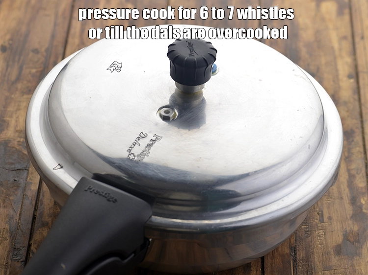 Step 9 – <p>Pressure cook for 6 to 7 whistles or till the dals are overcooked. Both the …