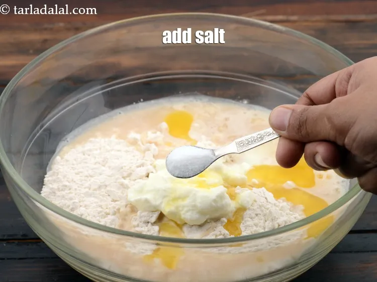 Step 10 – <p>Add <span style="background-color:rgb(255,255,255);color:rgb(0,0,0);">remaining </span><a href="https://www.tarladalal.com/glossary-sugar-chini-shakkar-278i"><u>sugar</u></a><span style="background-color:rgb(255,255,255);color:rgb(0,0,0);">, add 1/2 cup </span><a href="https://www.tarladalal.com/glossary-butter-makhan-233i#ing_3123"><u>melted butter</u></a>, add <span style="background-color:rgb(255,255,255);color:rgb(0,0,0);">1/2 …