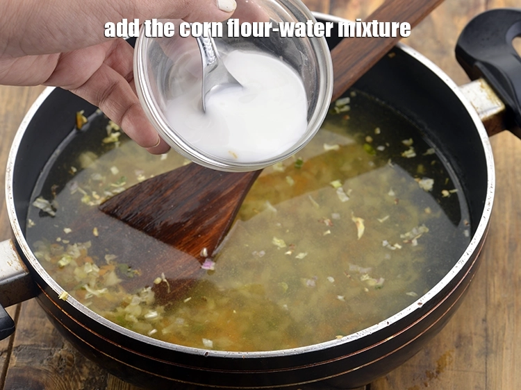 Step 26 – <p>Now, add the <strong>corn flour-water mixture</strong>. This cornflour slurry will give your soup the desired …