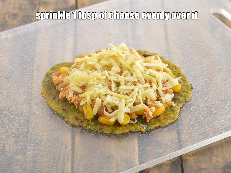 Step 20 – <p><span style="background-color:rgb(255,255,255);color:rgb(0,0,0);">Sprinkle 1 tbsp of </span><a href="https://www.tarladalal.com/glossary-processed-cheese-315i#ing_3090"><u>grated processed cheese</u></a><span style="background-color:rgb(255,255,255);color:rgb(0,0,0);"> evenly over it.</span></p>