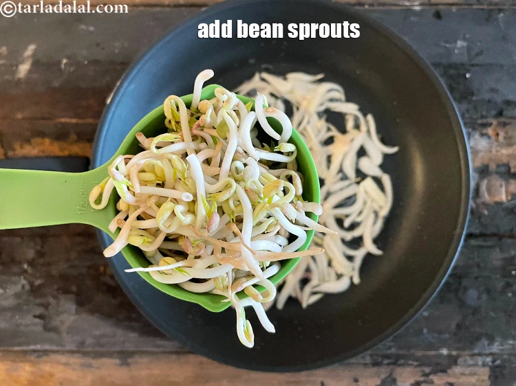 Step 7 – <html><head></head><body><p>Add&nbsp;2 tbsp&nbsp;<a href="glossary-bean-sprouts-193i">bean sprouts</a>. Mix well. Cook on a high flame for 1 minute.</p></body></html>