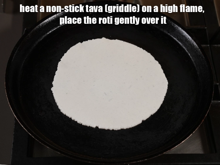 Step 21 – <p>Heat a non-stick tava (griddle) on a high flame. When hot, place the <strong>roti</strong> gently …